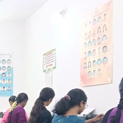 Posters with photographs of students who passed, on the classroom wall
